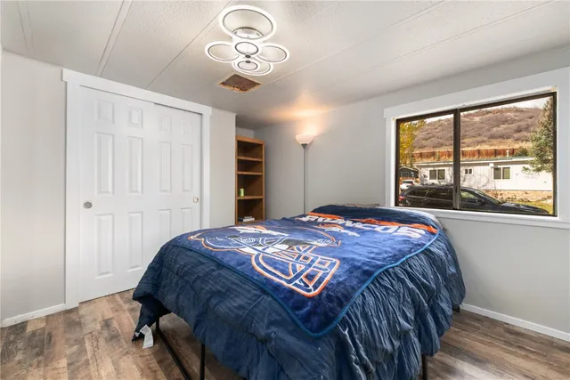 a bedroom with a large bed and a large window