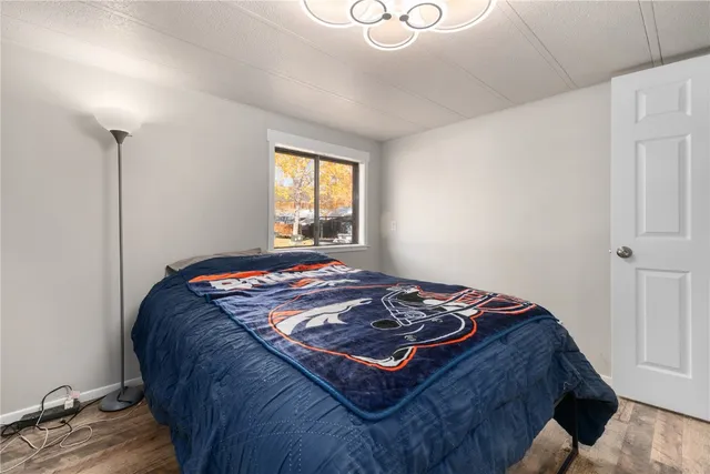 a bed sitting in a bedroom next to a window