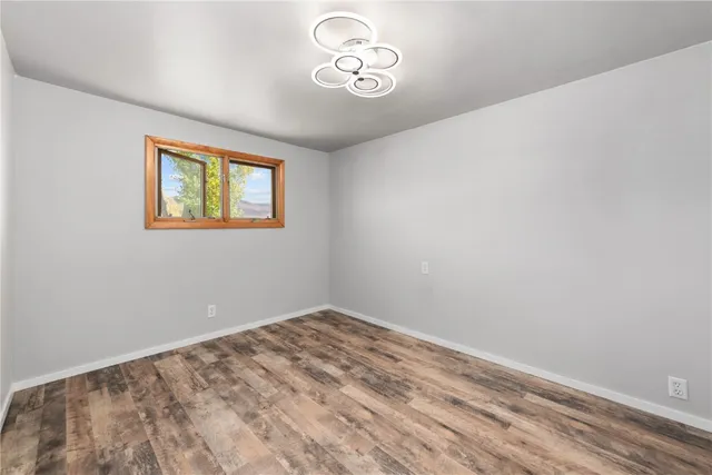 a view of room with hardwood floor and ceiling fan