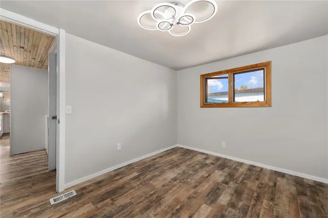 a view of a hallway with a chandelier fan
