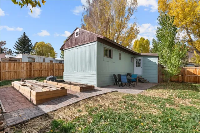 a view of a backyard with chairs and a patio