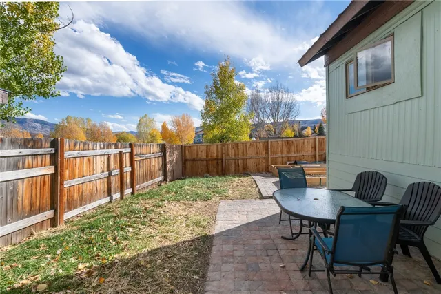 a view of a chair and table in backyard