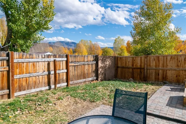 a view of a backyard with wooden fence