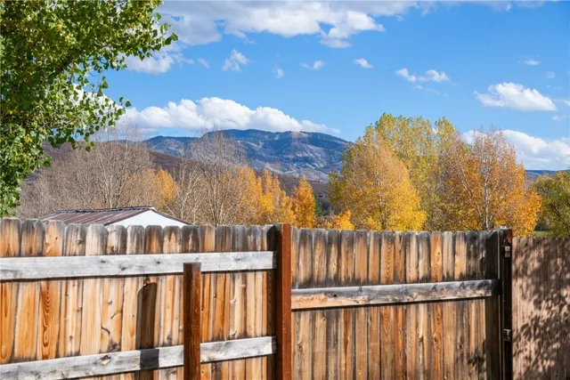 a view of a house with wooden fence