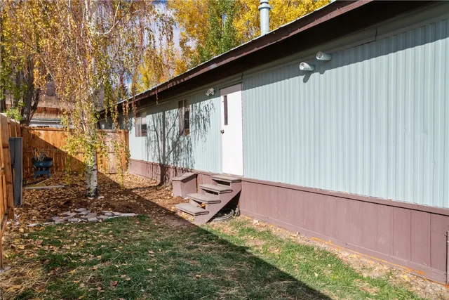a backyard of a house with table and chairs