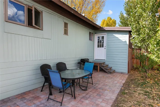 a backyard of a house with table and chairs