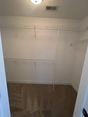 a view of a field with a lake in the background