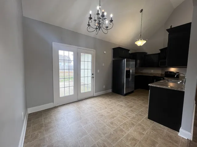 a view of a kitchen with a stove cabinets and a chandelier