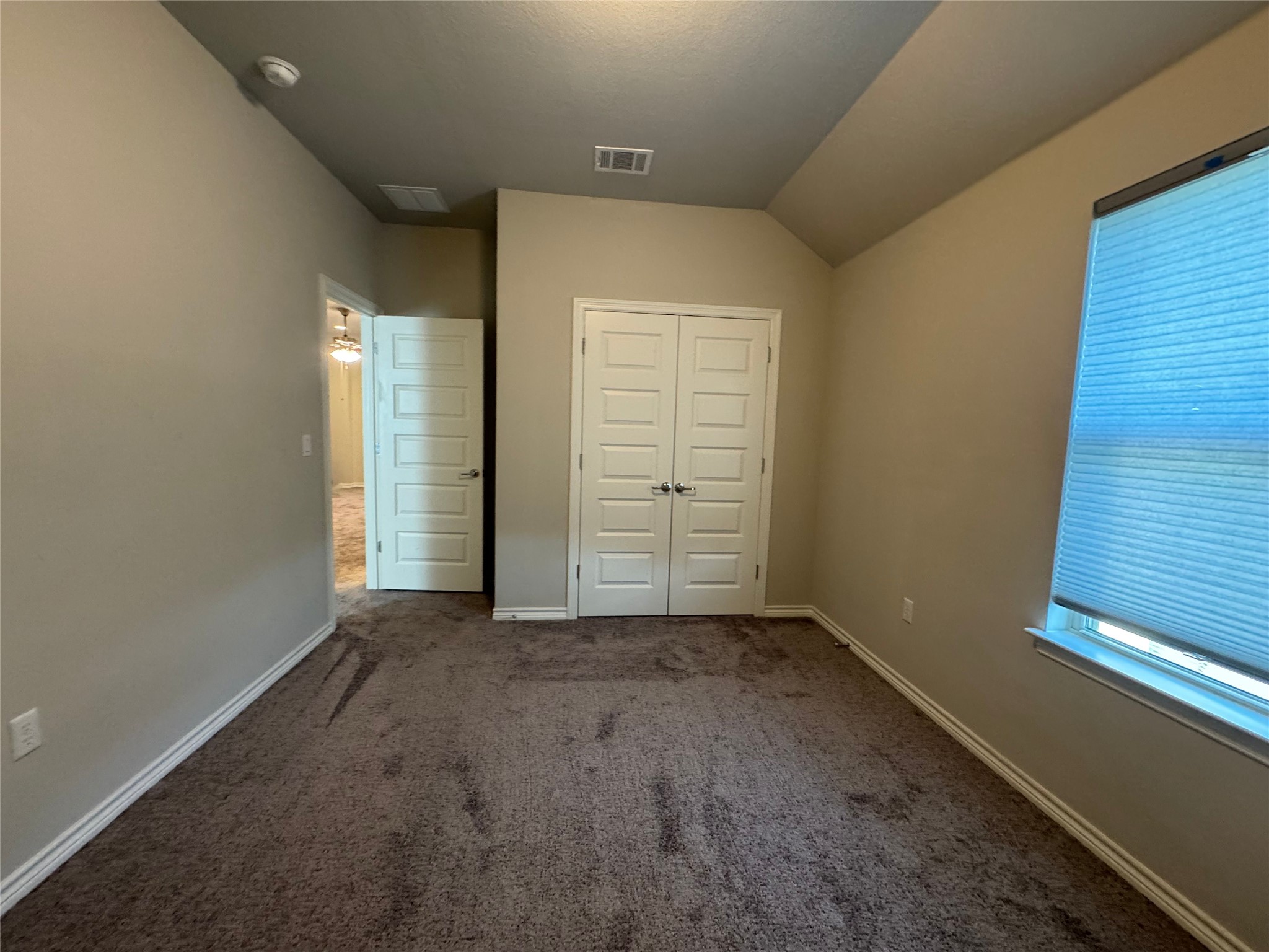 14100 McCoy Loop, Unit 1 Austin, TX 78717 - Photo 28 of 39 A well-lit bedroom offering a warm, inviting atmosphere with ample floor space and convenient closet access.