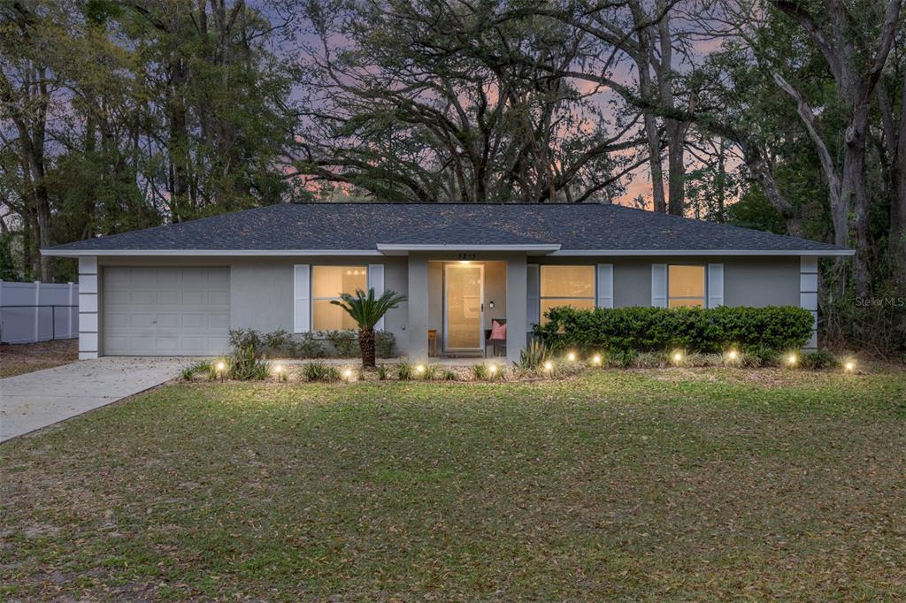 5255 Northwest 64 Street Ocala, FL 34482 - Photo 1 of 24 a front view of a house with a yard and porch