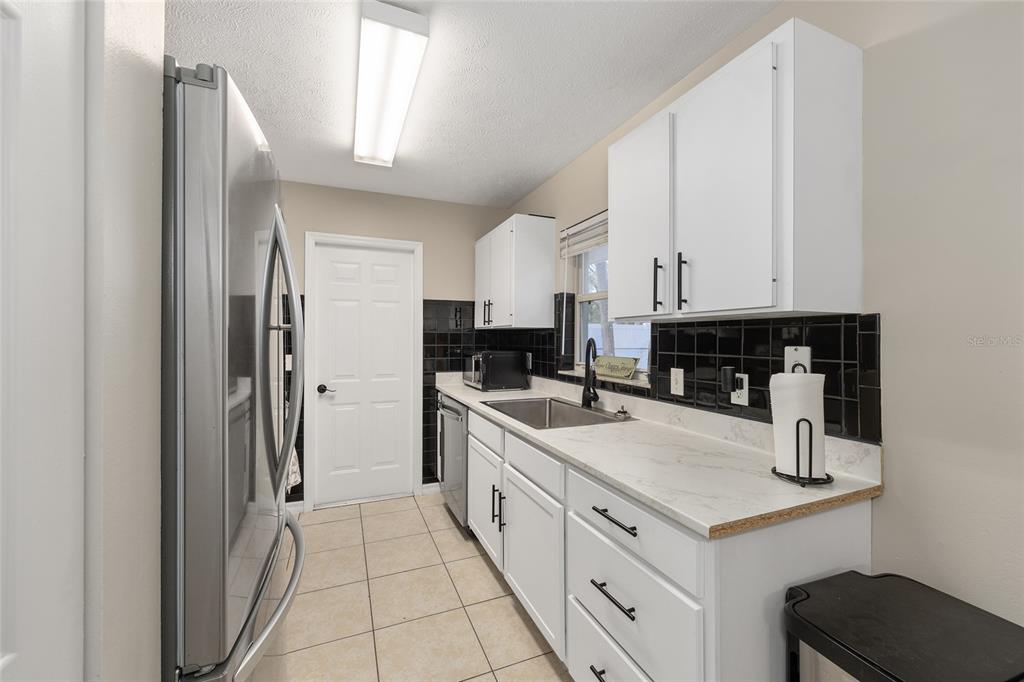 5255 Northwest 64 Street Ocala, FL 34482 - Photo 12 of 24 a kitchen with stainless steel appliances granite countertop a refrigerator and a stove