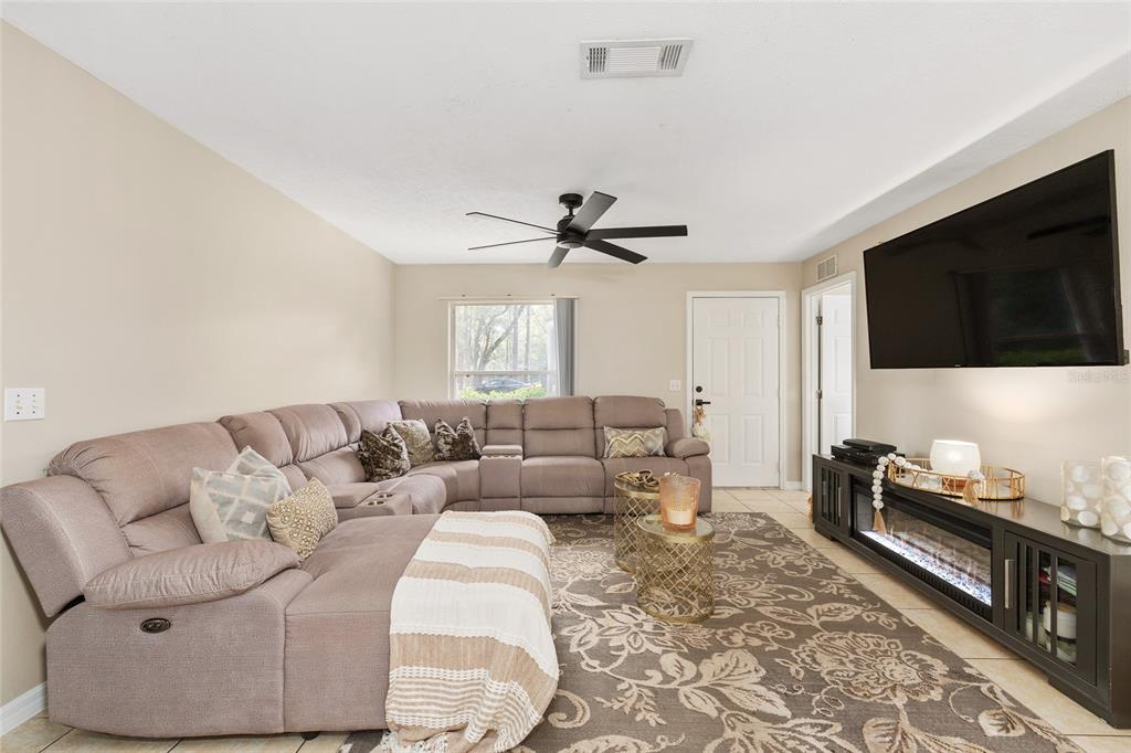 5255 Northwest 64 Street Ocala, FL 34482 - Photo 7 of 24 a living room with furniture and a flat screen tv