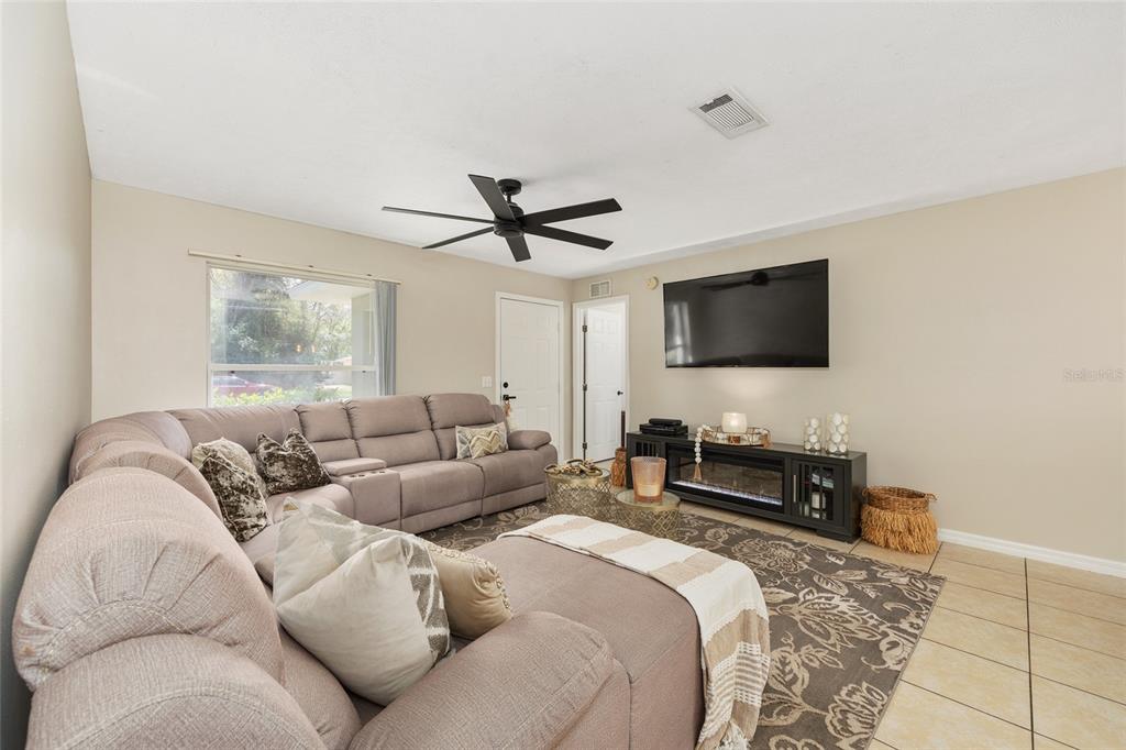 5255 Northwest 64 Street Ocala, FL 34482 - Photo 8 of 24 a living room with furniture a flat screen tv and a window