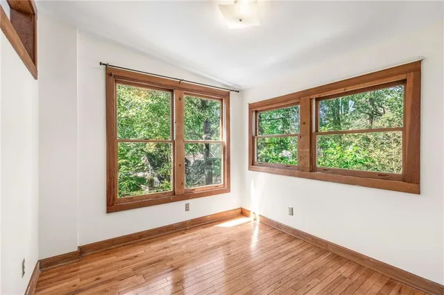 a view of a room with wooden floor and a bathroom