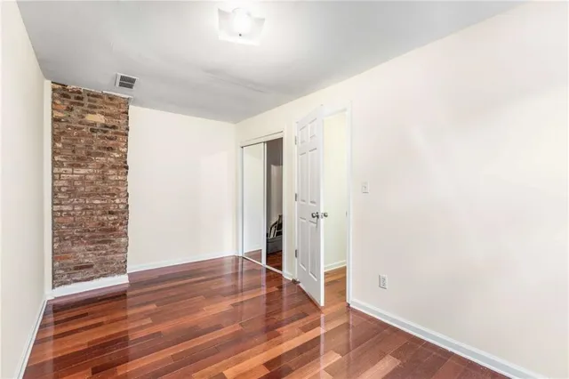 a view of living room with furniture and wooden floor