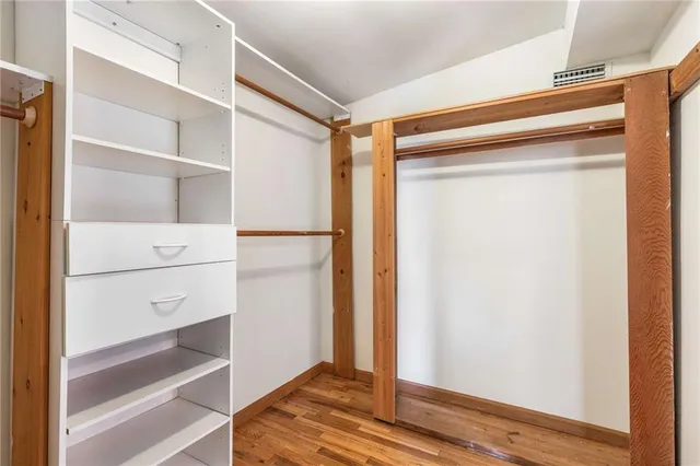 a bathroom with a sink a toilet a mirror and shower