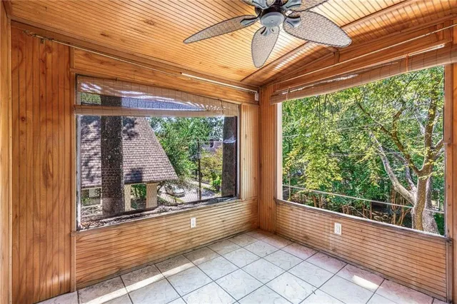 a view of a livingroom with furniture a ceiling fan and wooden floor