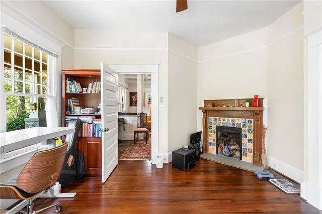 a view of a hallway with wooden floor and a bedroom