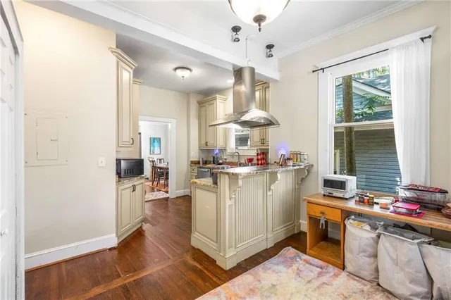 a kitchen with stainless steel appliances granite countertop a stove and a wooden floors