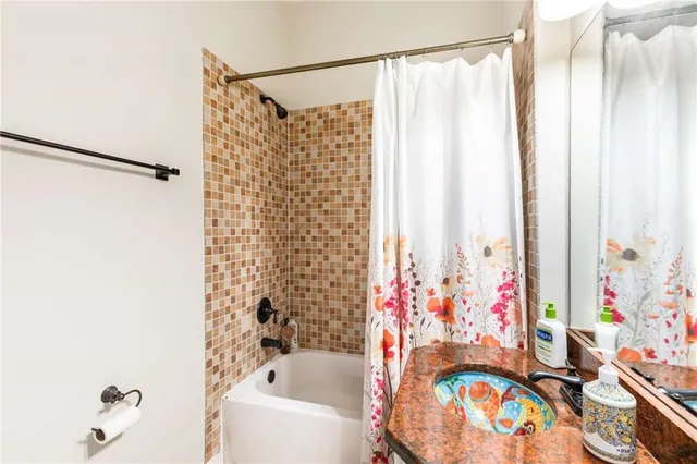 a view of a house with wooden fence