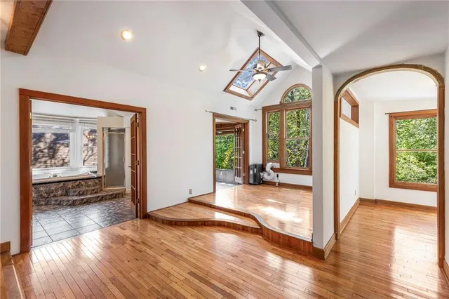 a yellow and red house sitting next to a yard