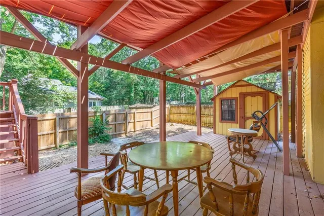 a kitchen with stainless steel appliances kitchen island granite countertop a sink stove and wooden cabinets