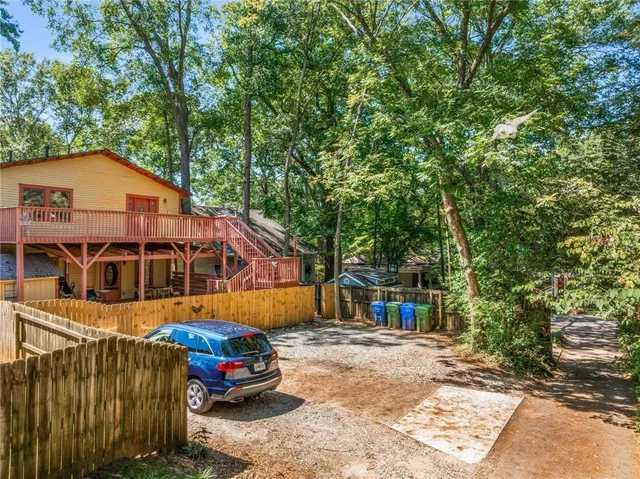 a living room with furniture a chandelier and a dining table