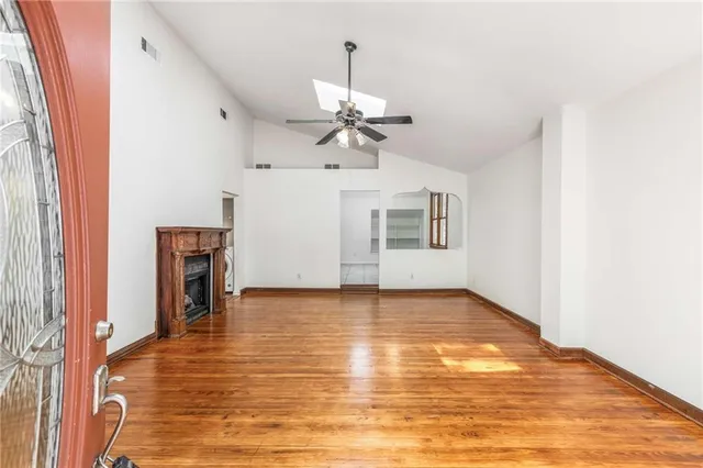 wooden floor in an empty room with a window
