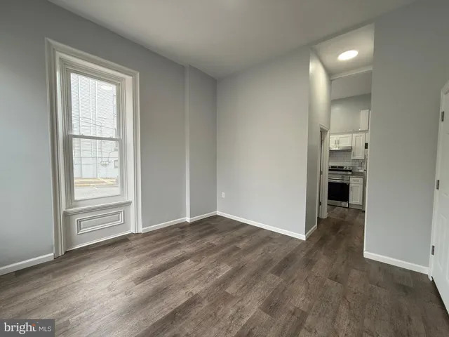 an empty room with closet and windows