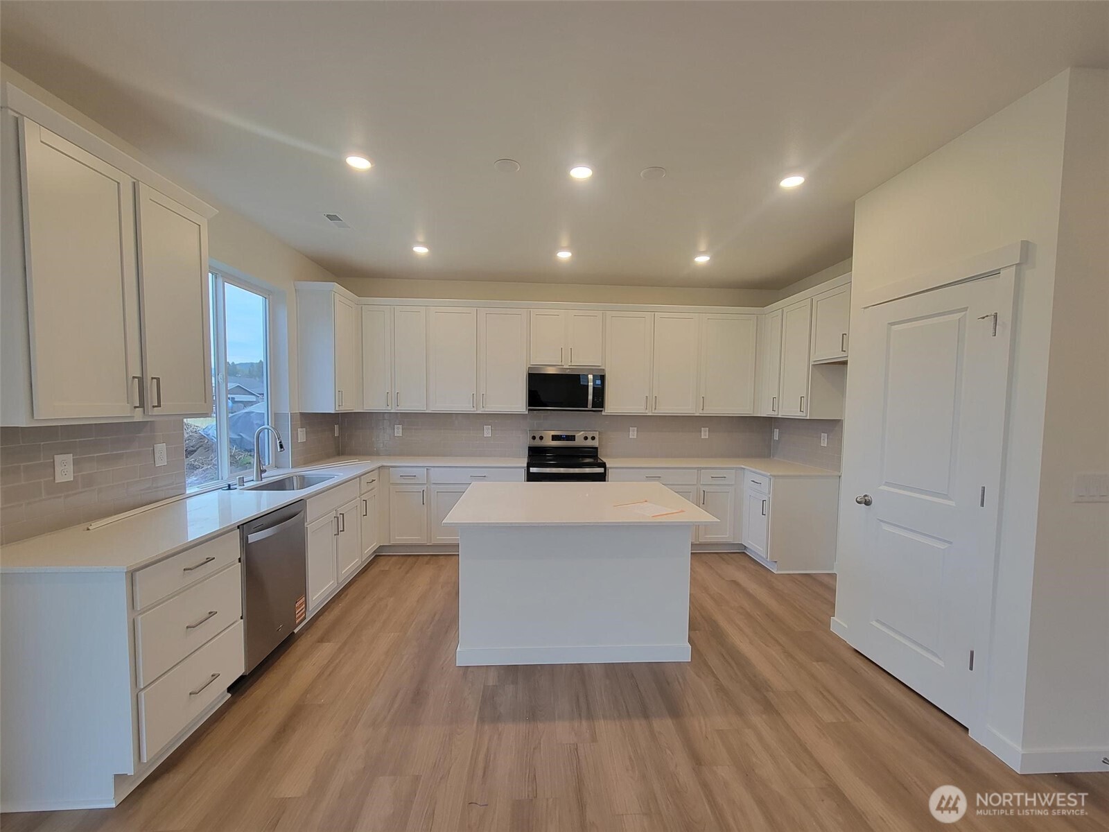 748 Holly Avenue, Unit 39 Buckley, WA 98321 - Photo 13 of 29 a large kitchen with stainless steel appliances granite countertop a stove a sink and a refrigerator