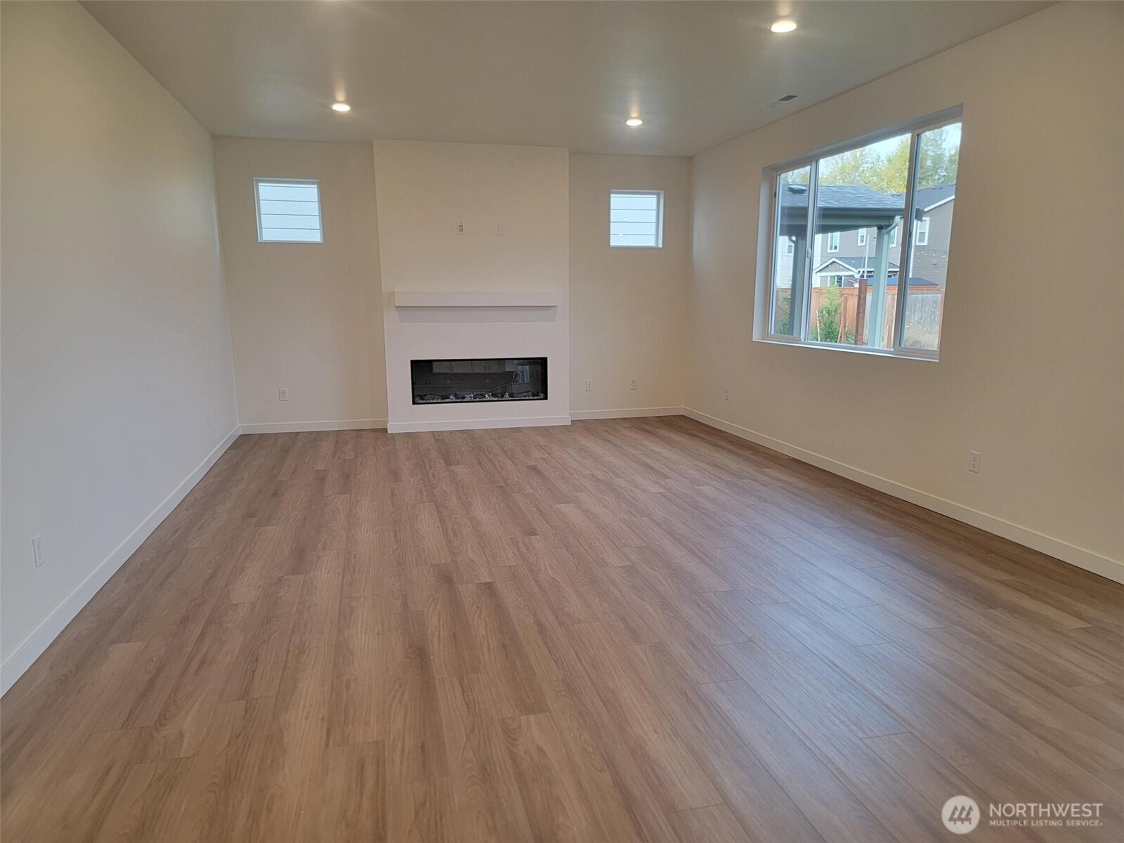 748 Holly Avenue, Unit 39 Buckley, WA 98321 - Photo 15 of 29 an empty room with wooden floor and windows