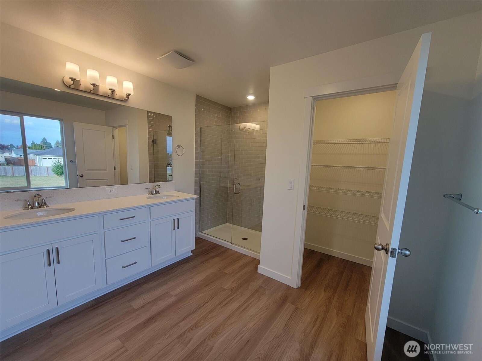 748 Holly Avenue, Unit 39 Buckley, WA 98321 - Photo 21 of 29 a spacious bathroom with a double vanity sink a large mirror and shower