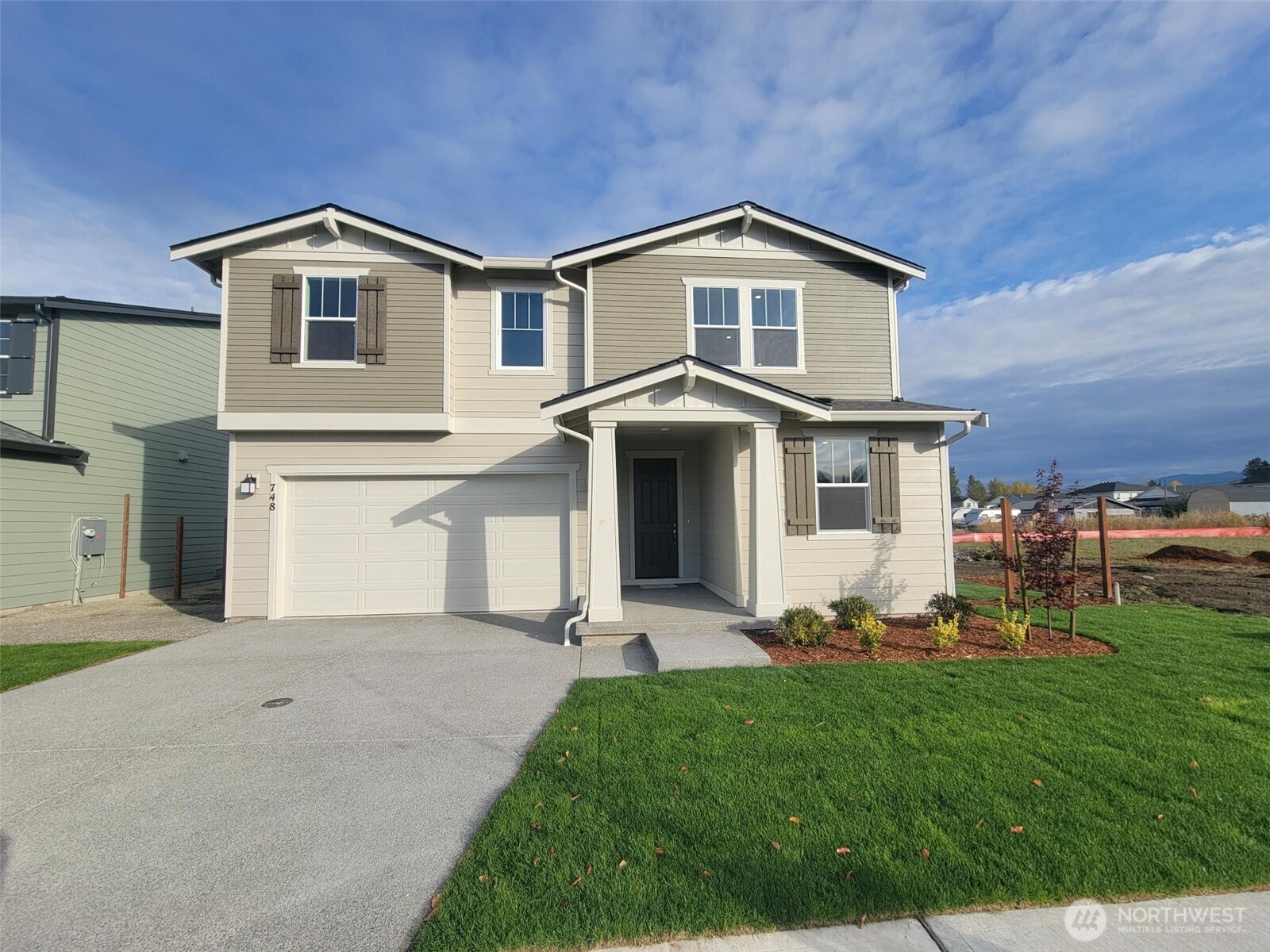 748 Holly Avenue, Unit 39 Buckley, WA 98321 - Photo 8 of 29 a front view of a house with a yard and trees