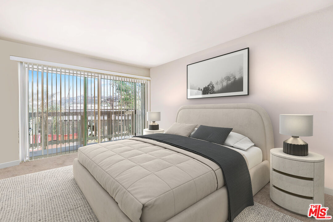 6690 Vista Del Mar, Unit E Playa del Rey, CA 90293 - Photo 7 of 12 a bedroom with a large bed and a large window