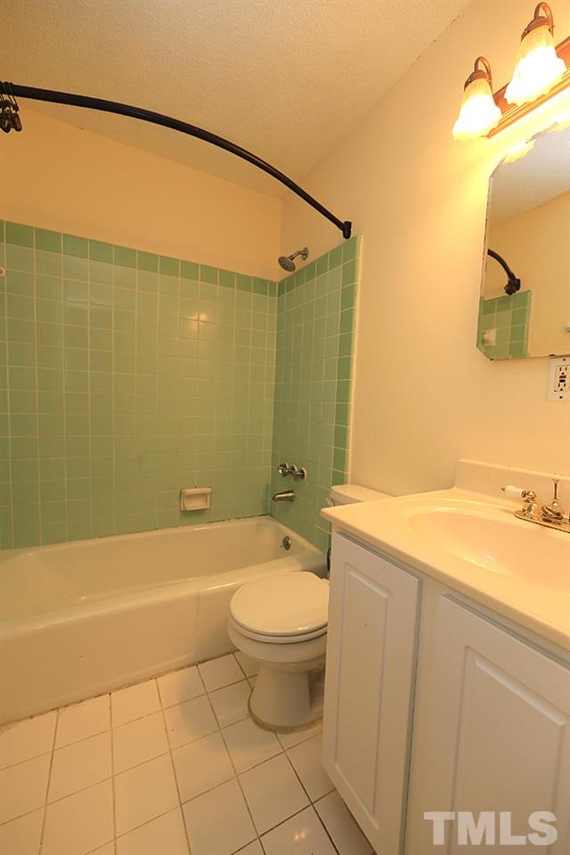 149 Jones Franklin Road, Unit H Raleigh, NC 27606 - Photo 8 of 12 a bathroom with a granite countertop sink toilet and shower