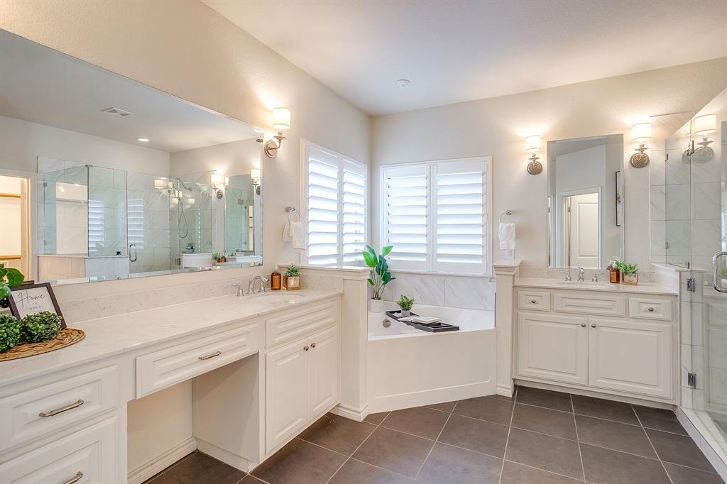 100 Grey Stone Street Aledo, TX 76008 - Photo 17 of 40 a large white bathroom with a large mirror vanity and a bathtub
