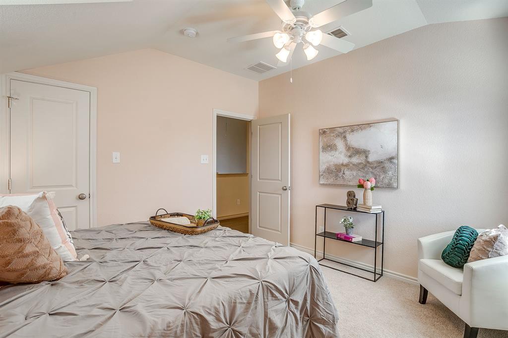 100 Grey Stone Street Aledo, TX 76008 - Photo 24 of 40 a bedroom with a bed and a chandelier
