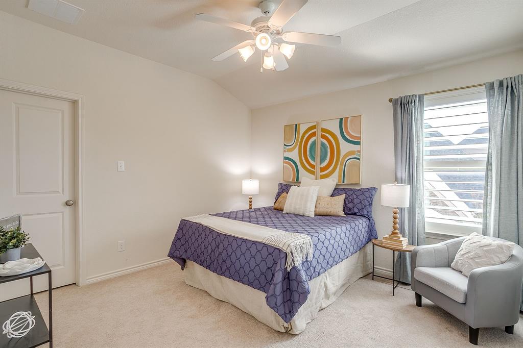100 Grey Stone Street Aledo, TX 76008 - Photo 26 of 40 a bedroom with a bed and a chandelier