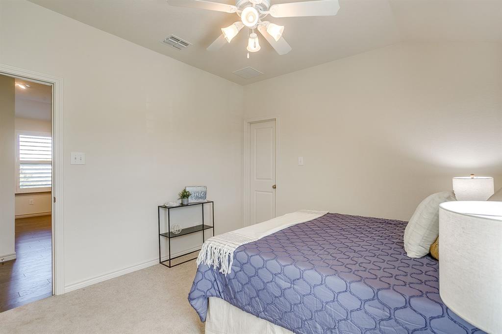 100 Grey Stone Street Aledo, TX 76008 - Photo 27 of 40 a bedroom with a bed and a chandelier