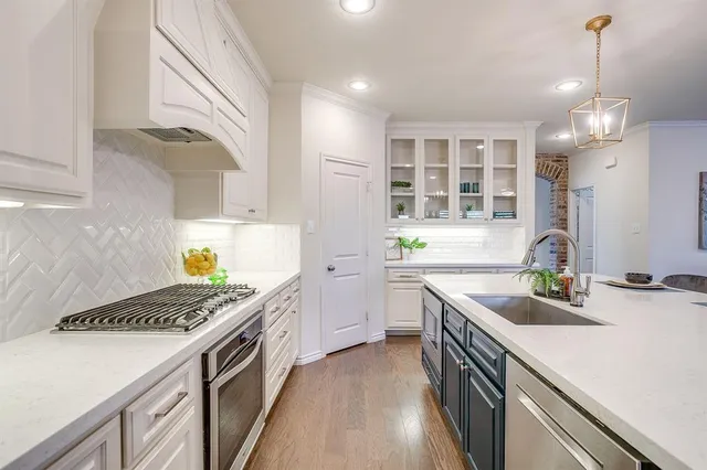 a kitchen with a sink stove and wooden cabinets