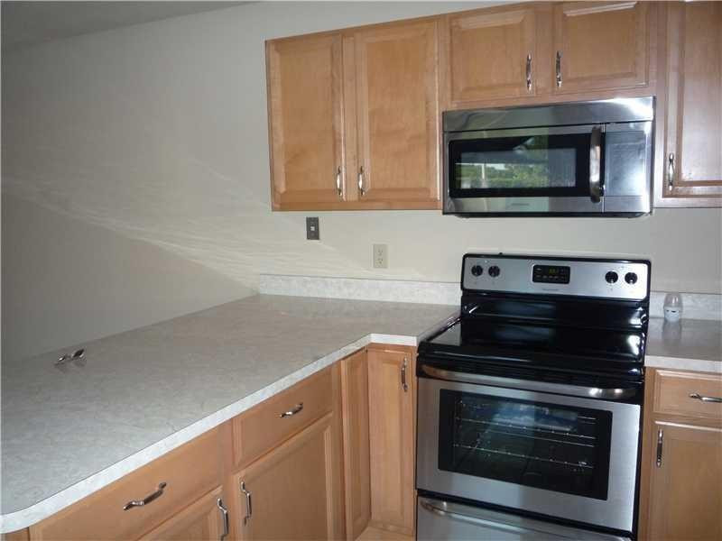 a kitchen with stainless steel appliances a stove a microwave and cabinets