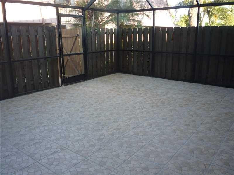 7539 Courtyard Run East Boca Raton, FL 33433 - Photo 2 of 3 a view of backyard with wooden fence