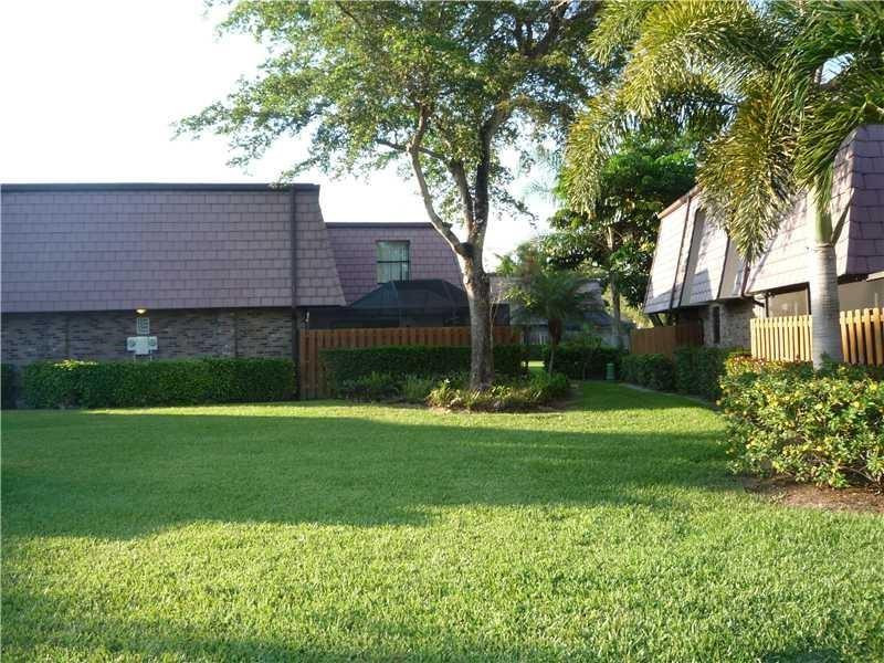 7539 Courtyard Run East Boca Raton, FL 33433 - Photo 3 of 3 a front view of a house with a garden