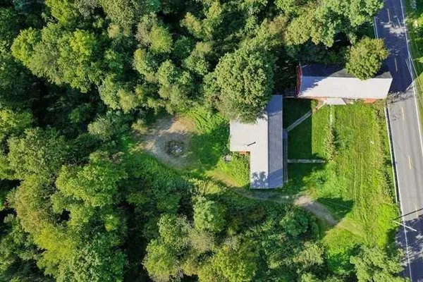 an aerial view of a house with a yard