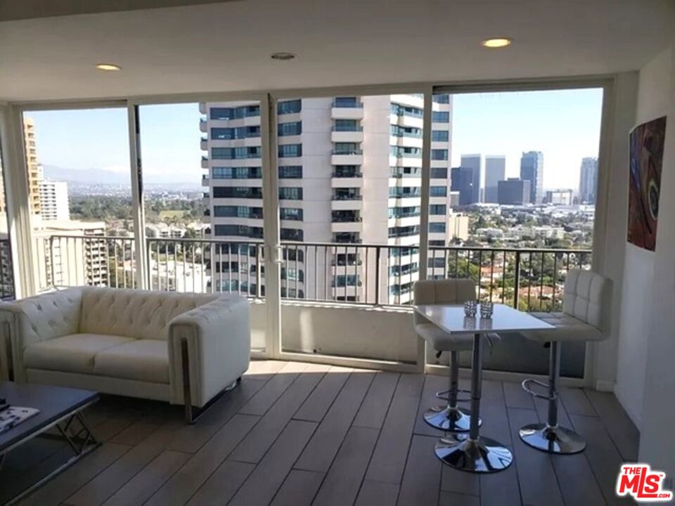 10501 Wilshire Boulevard, Unit 2103 Los Angeles, CA 90024 - Photo 2 of 19 a living room with furniture and a large window
