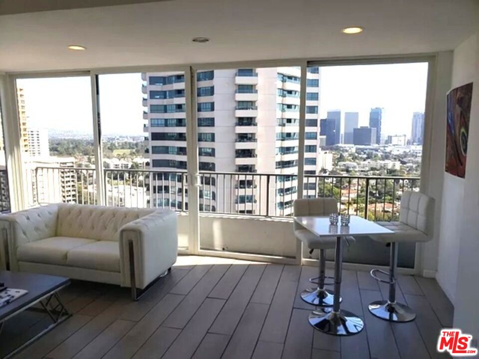 10501 Wilshire Boulevard, Unit 2103 Los Angeles, CA 90024 - Photo 6 of 19 a living room with furniture and a large window
