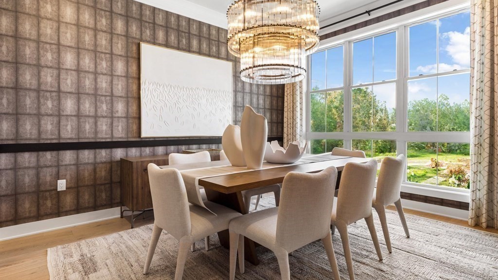 a dining room with furniture a chandelier and wooden floor