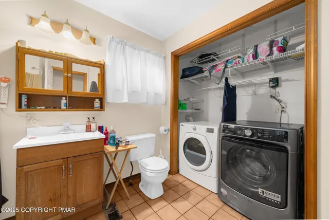 a bathroom with a sink a washer and dryer