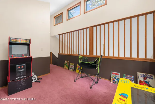 a living room with furniture and a air conditioner vent