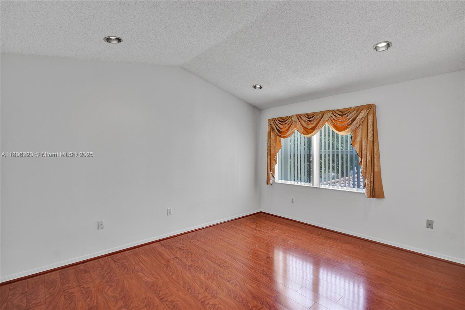3910 Fern Forest Road Cooper City, FL 33026 - Photo 15 of 38 an empty room with wooden floor and windows